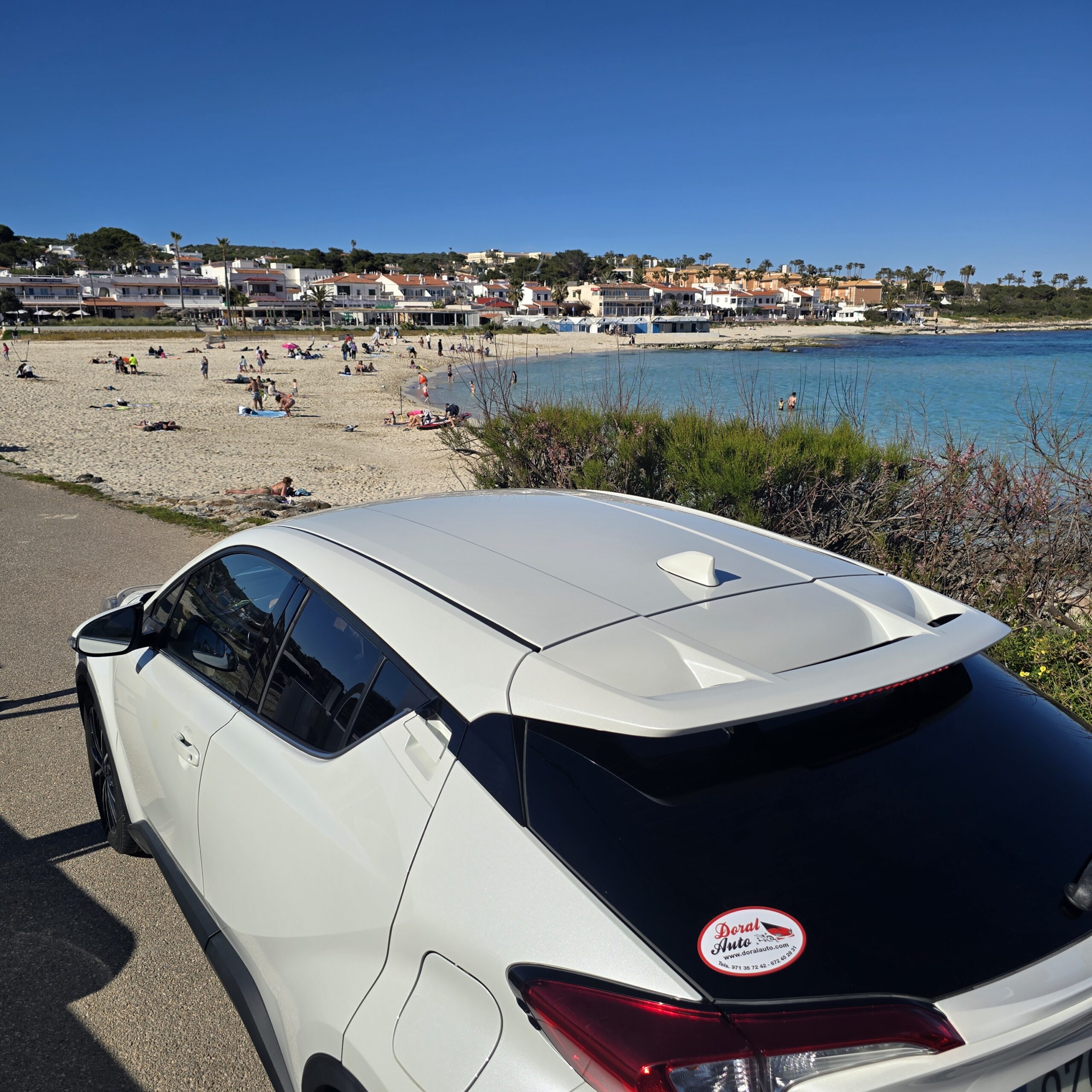 Tips for renting a car in Menorca next to a beach with crystal-clear waters